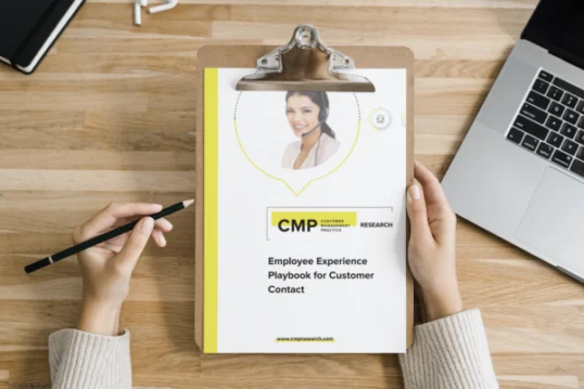 Person holding a clipboard with a document titled "Employee Experience Playbook for Customer Contact" from CMP Research, next to a laptop and notebook on a wooden desk.