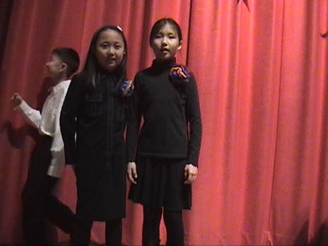 christine and shiwon posing for a fifth grade performance