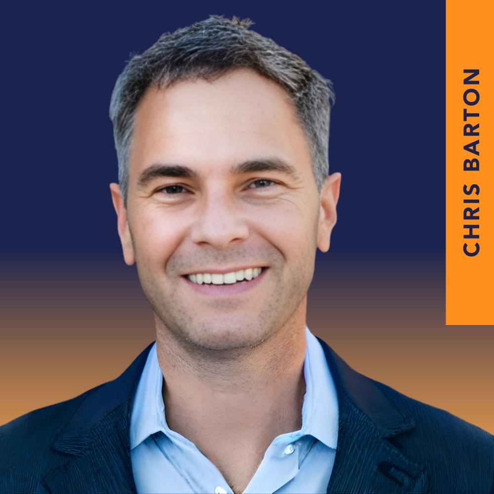 Smiling man with short gray hair in a blue shirt and dark blazer, with "Chris Barton" written vertically on an orange strip to the right.