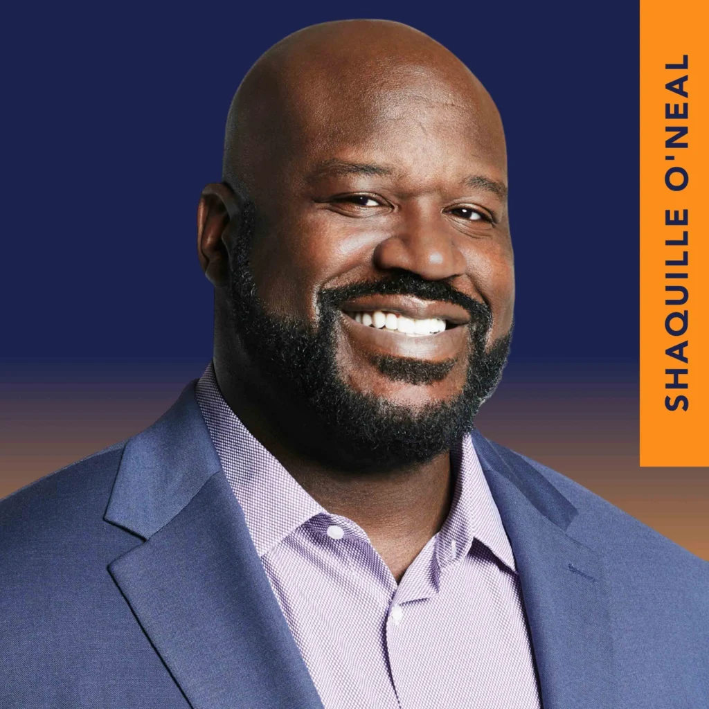 A man in a blue suit jacket and light purple shirt smiles at the camera. The background is dark blue with an orange vertical strip labeled "SHAQUILLE O'NEAL.