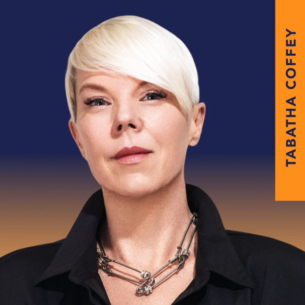 A person with short, platinum blonde hair and a black collared shirt, wearing a chunky silver necklace, is shown against a blue and orange background with the text "Tabatha Coffey.