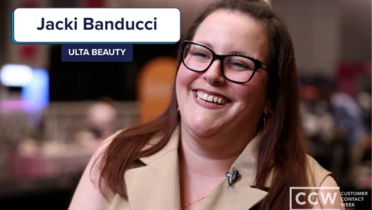 A woman wearing glasses and a beige top smiles at an event; text on screen reads "Jacki Banducci, Ulta Beauty" and "CCW Customer Contact Week.