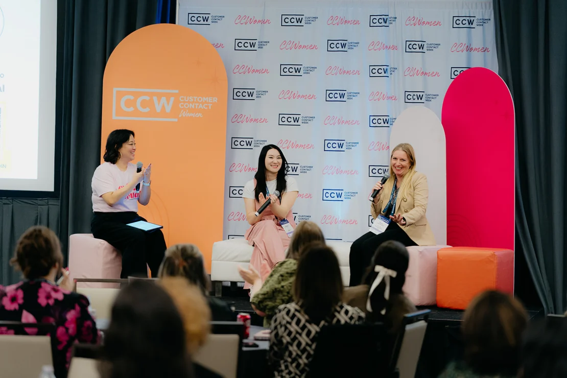 Three women sit and speak on stage during a panel discussion at a CCW Customer Contact Women event, with an audience in the foreground.
