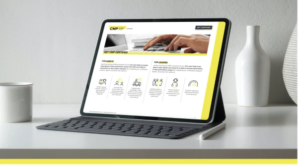 Tablet with keyboard and stylus displaying a certification webpage, placed on a white desk with a cup and two decorative vases in the background.