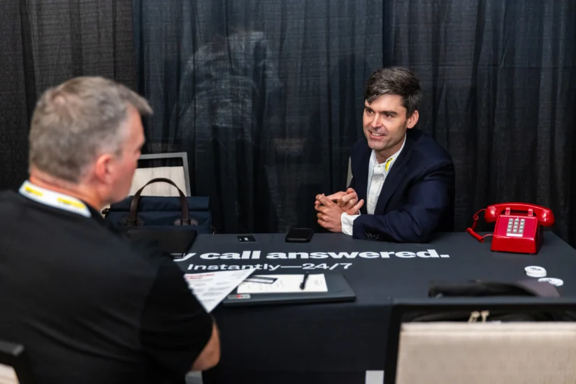 Two people in a focused one on one conversation at a table