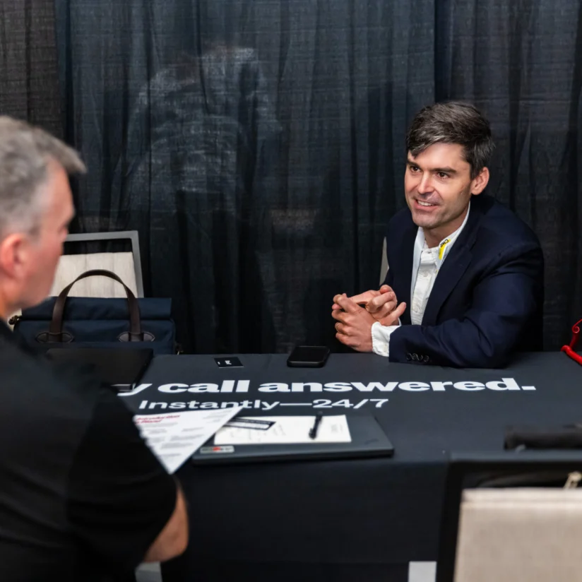Two people in a focused one on one conversation at a table