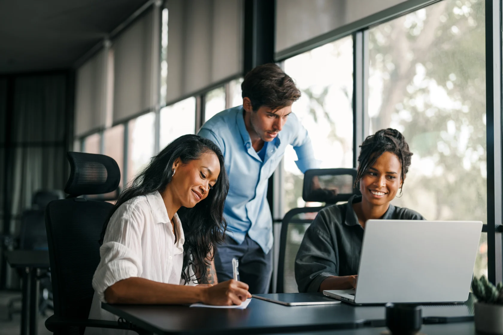 Group of busy happy diverse professional business team people working in office using digital tablet. Multiethnic young startup team working on a project together