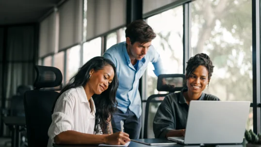 Group of busy happy diverse professional business team people working in office using digital tablet. Multiethnic young startup team working on a project together