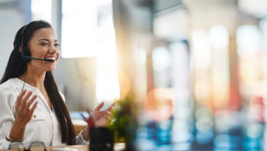 Call center, customer service and woman in office with bokeh for crm telemarketing consultation. Mockup space, contact us and professional female technical support agent with headset in workplace.